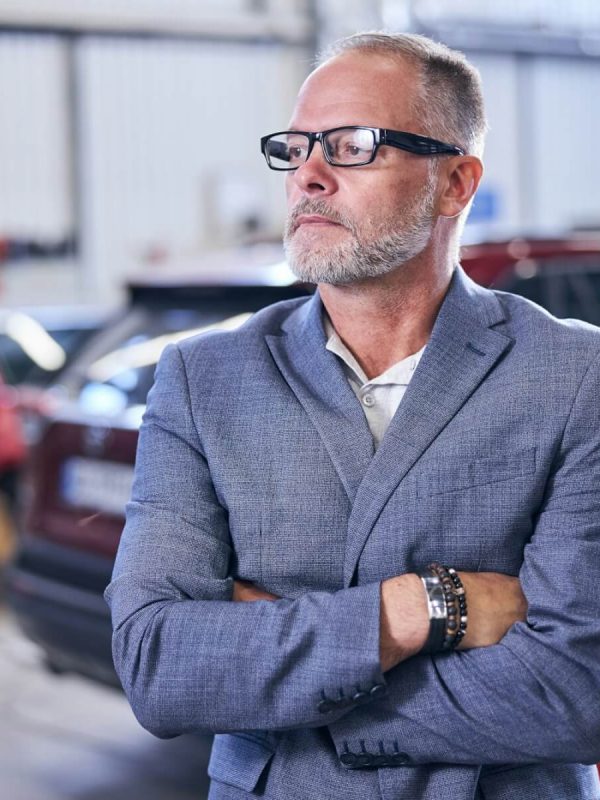 good-looking-bearded-man-standing-in-auto-repair-shop.jpg