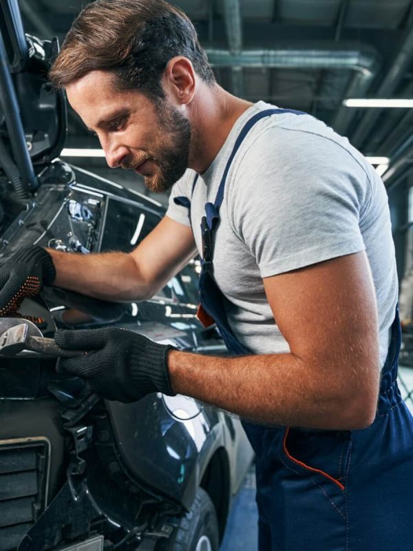 pleased-automotive-repairman-flattening-component-part-of-car.jpg